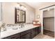 Well-lit bathroom vanity featuring a modern sink, decorative mirror, and stylish accents at 7247 W Buckskin Trl, Peoria, AZ 85383