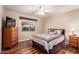 Comfortable bedroom featuring a cozy bed, hardwood floors, and a window with natural light to create a peaceful space at 7247 W Buckskin Trl, Peoria, AZ 85383