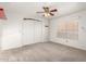 Bedroom featuring white walls and carpet, a ceiling fan, and a window with blinds for light control at 7247 W Buckskin Trl, Peoria, AZ 85383