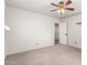 Bedroom with carpeted floors, showing a view into the hallway, bright with white walls and doors at 7247 W Buckskin Trl, Peoria, AZ 85383