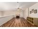 Bright bonus room with wood-look floors, ceiling fan, and cozy space for relaxation and entertainment at 7247 W Buckskin Trl, Peoria, AZ 85383