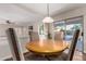 Dining area with wood table, upholstered chairs and pool area views at 7247 W Buckskin Trl, Peoria, AZ 85383