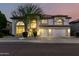 Charming stucco two-story home featuring a three-car garage and low-maintenance desert landscaping at 7247 W Buckskin Trl, Peoria, AZ 85383