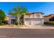 Attractive two-story stucco home with a three-car garage and low-maintenance desert landscaping at 7247 W Buckskin Trl, Peoria, AZ 85383