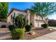 Attractive two-story home with desert landscaping, a three-car garage, and arched windows at 7247 W Buckskin Trl, Peoria, AZ 85383