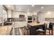 Bright kitchen with an island, stainless appliances, decorative backsplash and hardwood floors at 7247 W Buckskin Trl, Peoria, AZ 85383