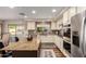 Open kitchen with island, stainless appliances and view of pool area at 7247 W Buckskin Trl, Peoria, AZ 85383
