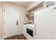 Laundry room with modern washer and dryer adjacent to a white refrigerator at 7247 W Buckskin Trl, Peoria, AZ 85383