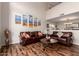 Living room with hard wood floors, leather couches, a coffee table, and artistic wall decor at 7247 W Buckskin Trl, Peoria, AZ 85383