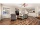 Open concept living room with wood floors and living room and kitchen area views at 7247 W Buckskin Trl, Peoria, AZ 85383