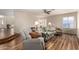 Open living room with plenty of natural light, wood floors, and casual seating at 7247 W Buckskin Trl, Peoria, AZ 85383