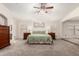 Comfortable main bedroom featuring a king bed, carpeted floors, and calming decor at 7247 W Buckskin Trl, Peoria, AZ 85383