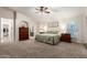 Spacious main bedroom with a ceiling fan, a king bed, and an ensuite bathroom providing the ultimate retreat at 7247 W Buckskin Trl, Peoria, AZ 85383