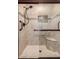 Modern bathroom shower featuring custom tile work, a sleek shower head, and a convenient built-in seat at 7247 W Buckskin Trl, Peoria, AZ 85383