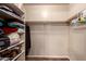 Organized walk-in closet featuring shelving and clothing rods for organized storage at 7247 W Buckskin Trl, Peoria, AZ 85383