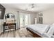 Bright bedroom featuring a desk, ensuite bathroom, light wood floors and French doors to the backyard at 7440 E Hubbell St, Scottsdale, AZ 85257
