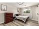 Well-lit bedroom with neutral walls, wood-look flooring, ceiling fan, and stylish furnishings at 7440 E Hubbell St, Scottsdale, AZ 85257