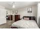 Bedroom with laminate flooring, large sliding closet doors, and desert-themed artwork at 7440 E Hubbell St, Scottsdale, AZ 85257