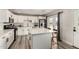 Modern kitchen with a central island, stainless appliances, and white cabinets at 7440 E Hubbell St, Scottsdale, AZ 85257