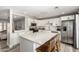 Bright kitchen features stainless steel appliances, a large island, and white cabinetry at 7440 E Hubbell St, Scottsdale, AZ 85257