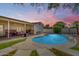 Beautiful backyard pool area with patio seating, lush landscaping, and evening ambiance at 7440 E Hubbell St, Scottsdale, AZ 85257