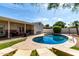 Outdoor view of a beautiful backyard pool, lounge chairs and covered patio at 7440 E Hubbell St, Scottsdale, AZ 85257