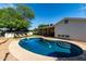 Beautiful backyard pool surrounded by gravel, lawn and lounge chairs at 7440 E Hubbell St, Scottsdale, AZ 85257