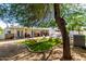 Backyard view of the pool, covered patio, lounge seating and lush lawn at 7440 E Hubbell St, Scottsdale, AZ 85257