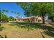 Expansive backyard featuring lush greenery, a pool, and covered patio at 7722 W Michigan Ave, Glendale, AZ 85308