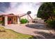 Large backyard with a basketball hoop, gravel landscaping, and lush greenery at 7722 W Michigan Ave, Glendale, AZ 85308