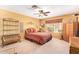 Cozy bedroom with ceiling fan, stylish decor, and ample space for comfortable living at 7722 W Michigan Ave, Glendale, AZ 85308