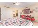 This bedroom features a cozy bed, quaint decor, and ample storage space with a large closet at 7722 W Michigan Ave, Glendale, AZ 85308
