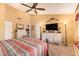 Bright bedroom with ceiling fan, walk-in closet, and dresser, offering both style and functionality at 7722 W Michigan Ave, Glendale, AZ 85308
