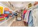 Walk-in closet with ample shelving and hanging space for organized storage at 7722 W Michigan Ave, Glendale, AZ 85308