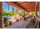 Inviting covered patio with view of pool, lush landscaping, and decorative features at 7722 W Michigan Ave, Glendale, AZ 85308