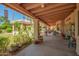 Spacious covered patio overlooking a lush garden and outdoor seating area at 7722 W Michigan Ave, Glendale, AZ 85308