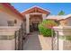 Inviting front entrance with decorative iron gate and covered entryway at 7722 W Michigan Ave, Glendale, AZ 85308
