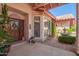 Charming porch featuring decorative plants and a cozy fountain at 7722 W Michigan Ave, Glendale, AZ 85308