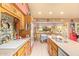 Charming kitchen featuring wood cabinets, decorative tile backsplash and breakfast nook with natural light at 7722 W Michigan Ave, Glendale, AZ 85308