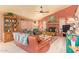 Cozy living room includes a ceiling fan, fireplace, and multiple seating options at 7722 W Michigan Ave, Glendale, AZ 85308