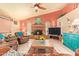 Bright living room features a fireplace, ceiling fan, and plenty of seating at 7722 W Michigan Ave, Glendale, AZ 85308