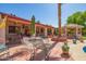 Spacious patio area featuring lounge furniture, table with umbrella, and convenient access to a charming gazebo at 7722 W Michigan Ave, Glendale, AZ 85308