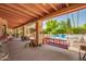 Covered patio with a porch swing overlooking a pool and landscaped backyard, perfect for outdoor living at 7722 W Michigan Ave, Glendale, AZ 85308