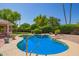 Beautiful in-ground swimming pool surrounded by lush landscaping at 7722 W Michigan Ave, Glendale, AZ 85308