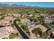 Aerial view showcases a scenic golf course, mountain views, and neighborhood of modern homes surrounded by desert landscape at 7775 E Fledgling Dr, Scottsdale, AZ 85255