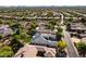Beautiful aerial view showcasing a home with solar panels, swimming pool, and desert landscaping in a golf community at 7775 E Fledgling Dr, Scottsdale, AZ 85255
