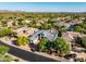 Aerial view showcases beautiful homes surrounded by lush greenery, offering stunning views and a serene neighborhood at 7775 E Fledgling Dr, Scottsdale, AZ 85255