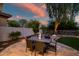 The outdoor dining area and mature trees make this backyard perfect for enjoying tranquil evenings at 7775 E Fledgling Dr, Scottsdale, AZ 85255