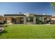 Stunning backyard featuring artificial grass, covered patio, and impeccable landscaping for outdoor living at 7775 E Fledgling Dr, Scottsdale, AZ 85255