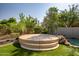 Outdoor patio area featuring a circular concrete stage in the garden, adding unique charm to the backyard at 7775 E Fledgling Dr, Scottsdale, AZ 85255